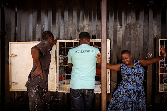Ketty Akello, who lives with Down Syndrome, dances with joy as Fred Alimet and her brother James buy supplies - and candy for Ketty - at the local store.