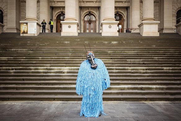 Rob Beamish from climate activist group Rouser protested the crackdown outside parliament on Wednesday in a costume made from attachment devices.