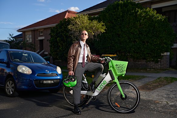 Eugenio Tarantola rides an e-bike to the office in Sydney.