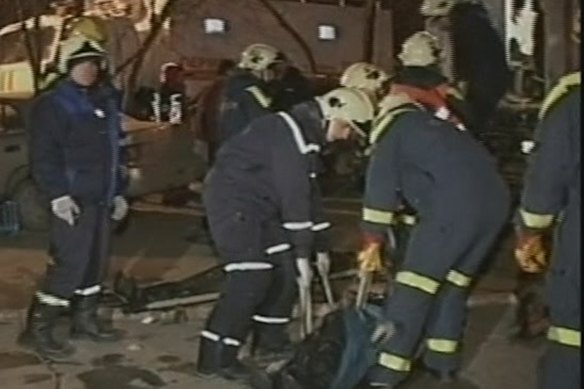 Rescuers retrieve the body of a victim outside a nightclub in Perm, Russia in December 2009.