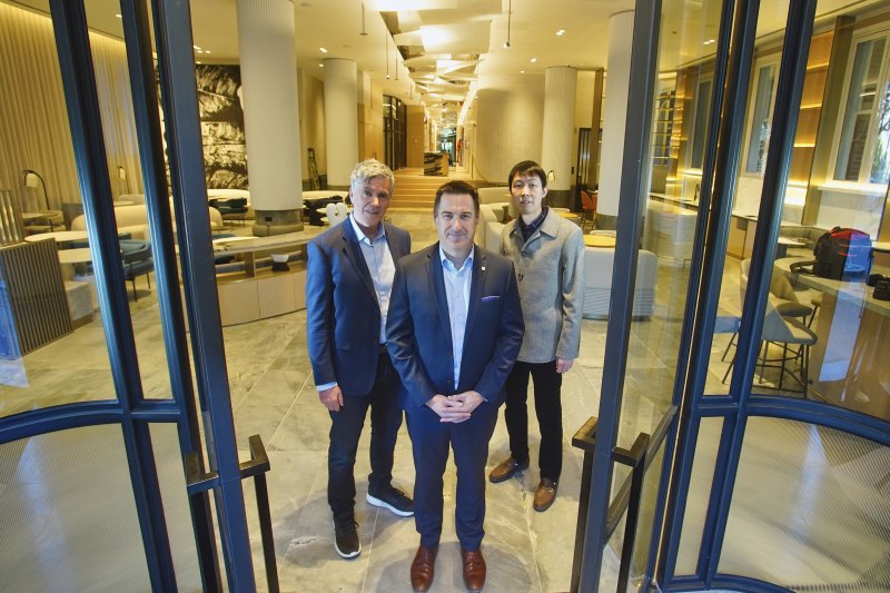 Preparing for a grand opening: Tony Tarros of Woodlink, Lanson Place general manager Marcus Packham and Xiaodan Zhu of Woodlink.