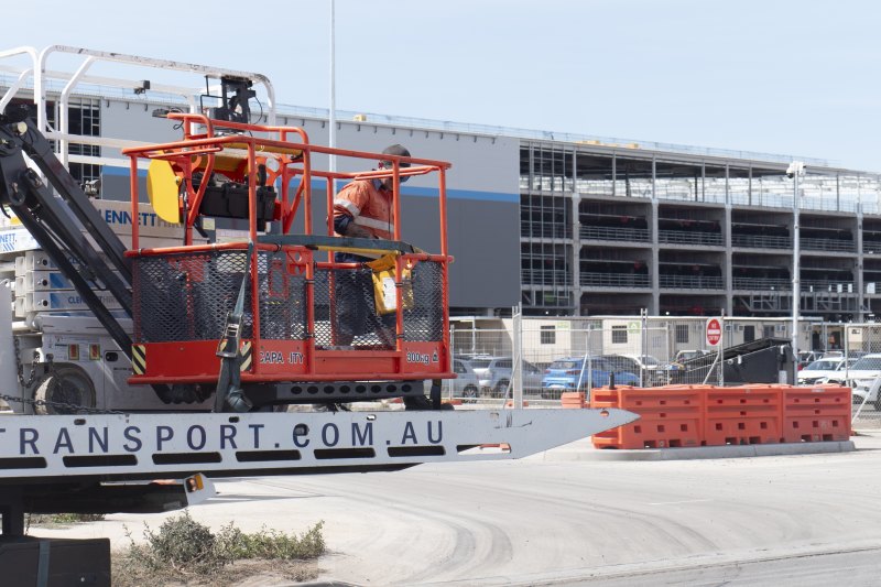 Workers removing equipment from the site of Amazon’s half-built four-level warehouse in Melbourne’s Craigieburn on Friday.