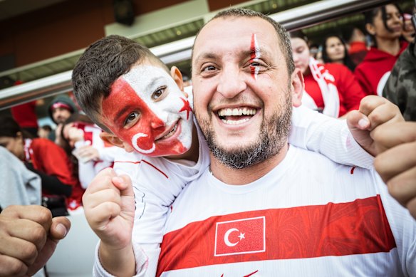 Turkish football fans Aren (left) and Ceyhun Erkan show their support for the national team at a live site as they watched the World Cup game between Turkey and Australia.