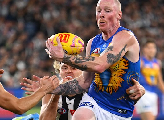 Darcy Moore (behind) has not played since straining his hamstring in a ruck contest with Eagle Bailey Williams.
