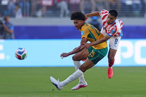 Lucas Herrington is challenged by Diego Gomez in the draw with Paraguay.