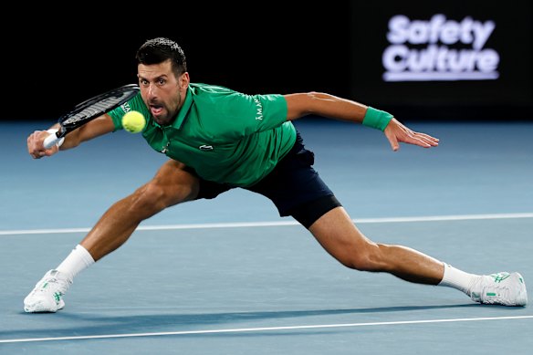 Novak Djokovic slides for a forehand in his opening-round victory at the Australian Open.
