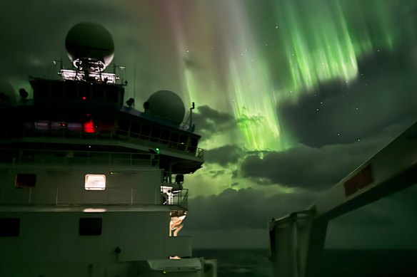 CSIRO flagship RV Investigator in Antarctica this summer, with Aurora Australis lighting up the sky.