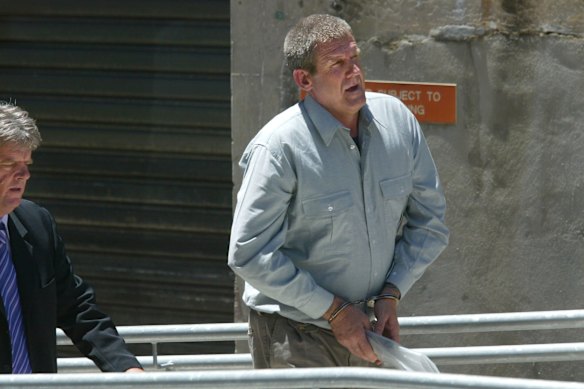 Convicted killer Bradley John Murdoch, pictured in handcuffs after facing an extradition hearing in Adelaide 2003, has died of throat cancer aged 67. 
