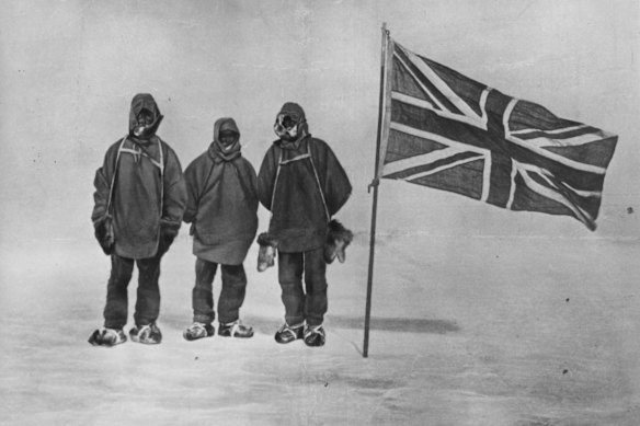 Irish explorer Sir Ernest Henry Shackleton, pictured circa 1909, with two members of his expedition team beside a Union Jack within 180 kilometres of the South Pole, a record feat at the time. 