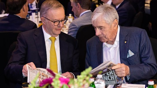 Kerry Stokes shows a copy of The West Australian to Anthony Albanese in 2022.