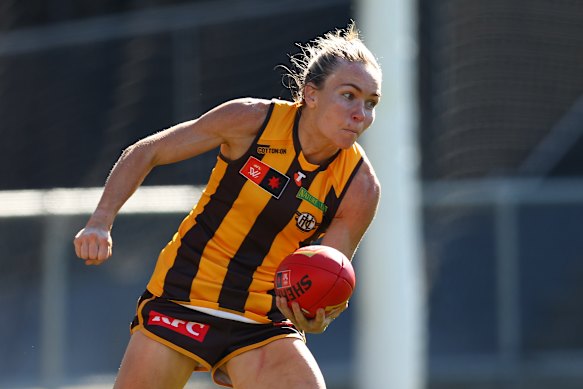 Emily Bates of the Hawks gets handball away in a practice match.