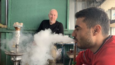 Stranded in Iraq: Michael Bachelard (left) interviews Issa Abdulqadir in a refugee camp in Iraqi Kurdistan.