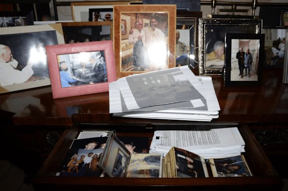 A photo taken of a cabinet in Jeffrey Epstein’s New York home, containing at least one image of US President Donald Trump (lower left).