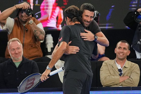 Novak Djokovic embraces Roger Federer