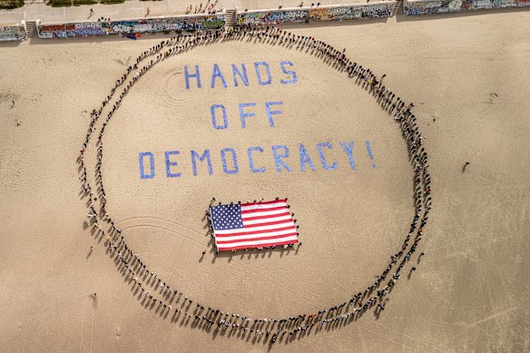 Protesters form a human banner on Ocean Beach, San Francisco.