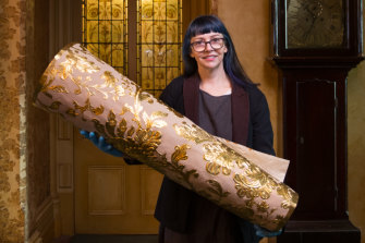 National Trust curator Elizabeth Anya-Petrivna with samples of the replica  Japanese wallpaper she hopes will be pasted on a wall at Rippon Lea.