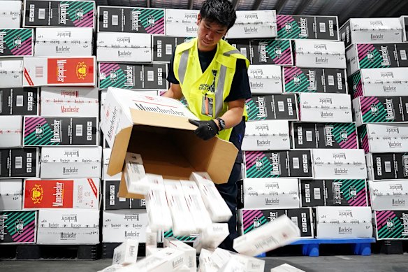 Australian Border Force officers checking illegal cigarette imports found in shipping containers in Melbourne.