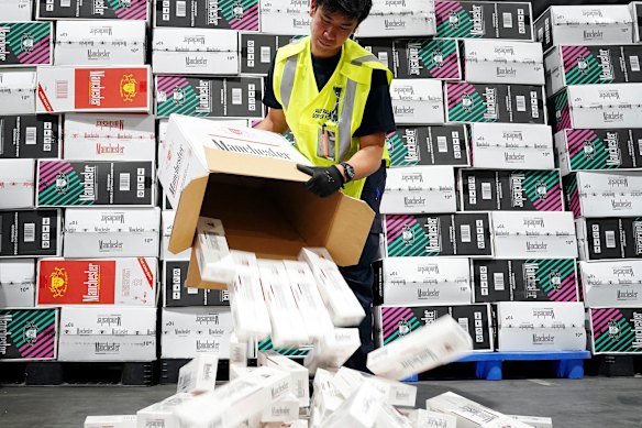 Australian Border Force officers checking illegal cigarette imports found in shipping containers in Melbourne.
