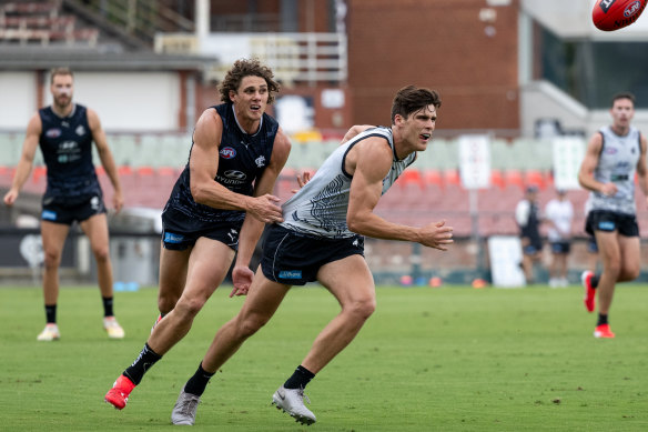 Charlie Curnow (left) goes through his paces at training this month, keeping tabs on Lewis Young.
