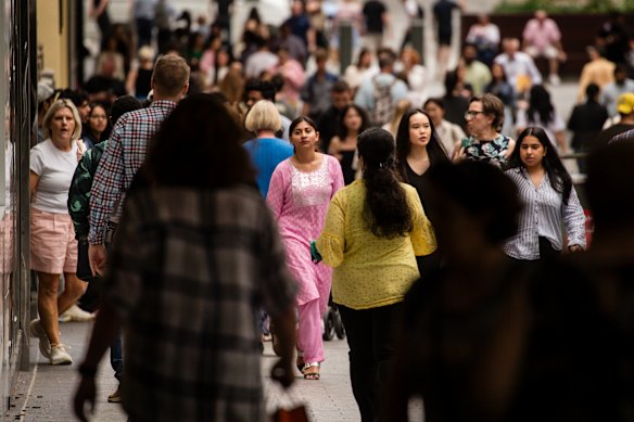 Shoppers pack Queen Street Mall.