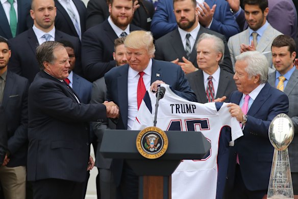 Robert Kraft hands over a Trump jersey at the White House during New England’s visit after winning the 2017 Super Bowl.