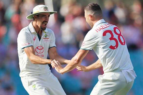 Josh Hazlewood of Australia celebrates a wicket with Mitchell Starc in January 2024. 