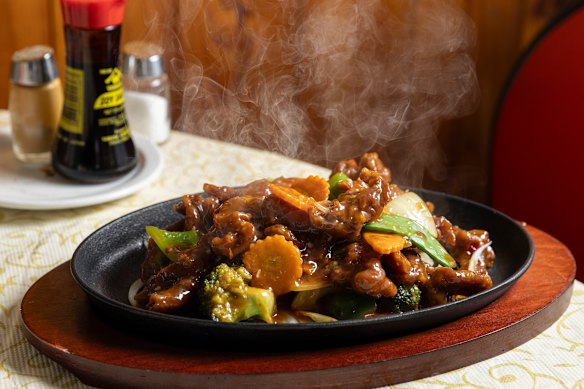 A skillet of sizzling Mongolian beef.