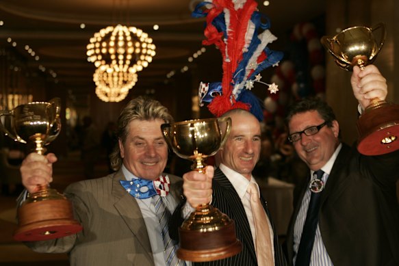 Makybe Diva’s owner Tony Santic (left), jockey Glenn Boss and trainer Lee Freedman celebrate a third Melbourne cup win.