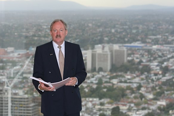 Sir Rod Eddington in 2008 with a copy of his report recommending the construction of the Melbourne Metro.