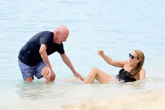Oops: Media mogul Rupert Murdoch and Jerry Hall have a little trouble leaving the water in Barbados.