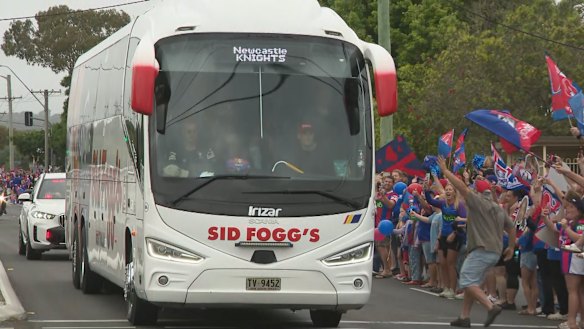 Newcastle fans line the streets as they cheer on the Knights aboard the bus to Sydney.