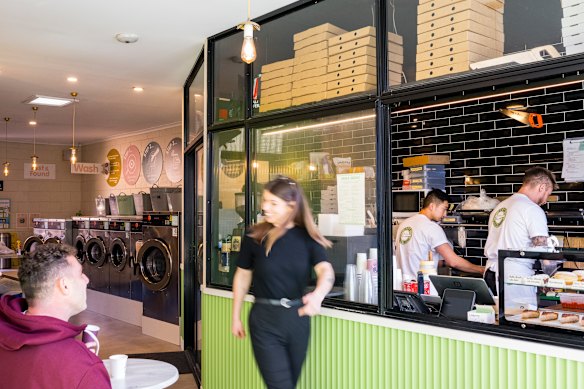 The pizza shop is housed inside a functioning laundromat in a glass-walled space that was about to be demolished.
