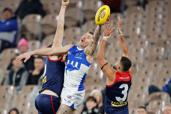 Cameron Zurhaar of the Kangaroos and Christian Salem of the Demons compete for the ball.