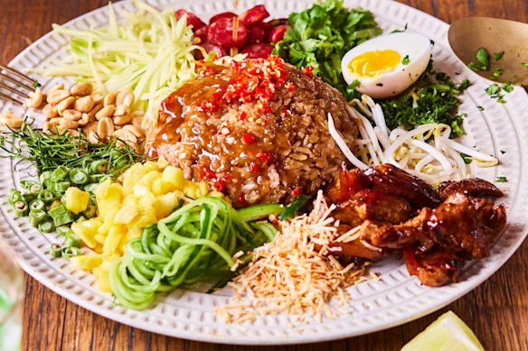 Toss the khao yum (Thai rice salad) to ensure maximum flavour in every bite.