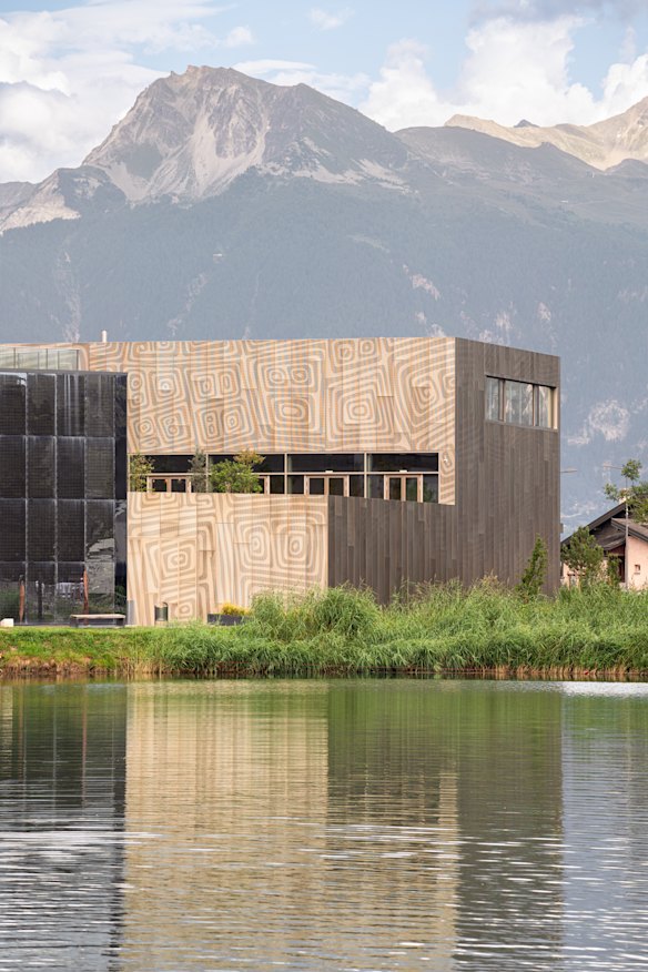 The impressive Fondation Opale nestled by a man-made lake in the Swiss Alps. 