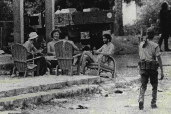 Four of the five Australian-based journalists who died, pictured at Balibo on the afternoon of October 15, before the attack. From left, Channel 9’s Brian Peters, Channel 7’s Gary Cunningham, Greg Shackleton (back to camera) and Tony Stewart from film taken by Portuguese TV crew.