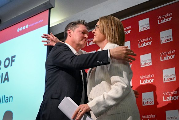 Allan and Deputy Premier Ben Carroll embrace on stage at Moonee Valley Racecourse.