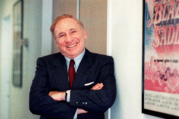Mel Brooks poses next to a framed poster of his 1974 film Blazing Saddles in Los Angeles in 1991. 