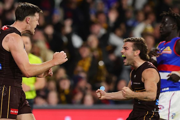 The tall and the short of it: Mitch Lewis and Nick Watson celebrate a goal.