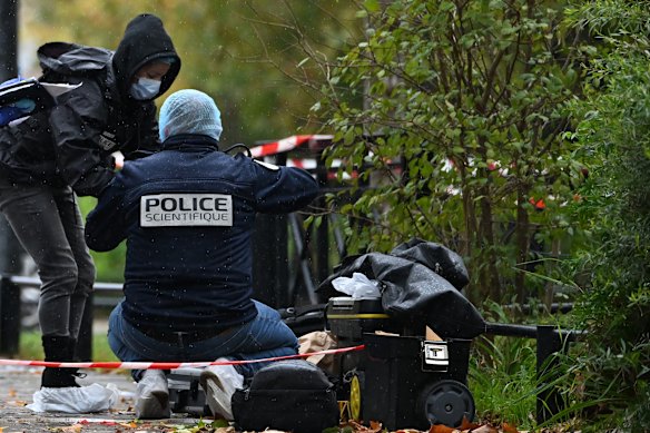 Forensic investigators search for evidence after a shooting in Trappes, outside Paris.