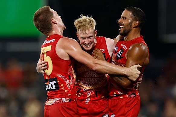 Gold Coast’s Noah Anderson and John Noble celebrate a goal with Touk Miller.