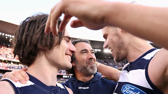 Gryan Miers and Jake Kolodjashnij with their coach Chris Scott (centre) after Geelong’s win in the 2022 grand final.