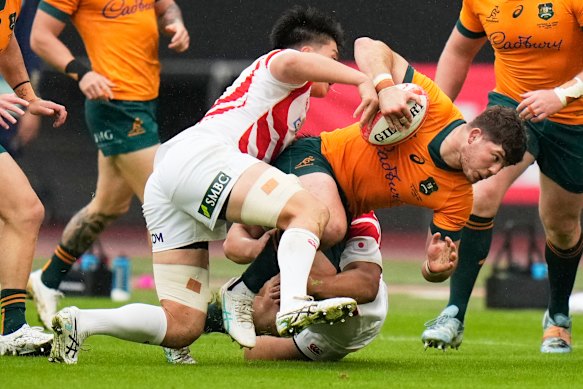 Australia’s Carlo Tizzano is tackled by defenders in Japan after an impressive performance.