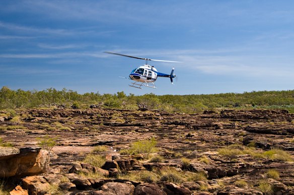 Helicopters, like this one at Mitchell Falls, are an essential form of transport in rugged, at times waterlogged  Kimberley.