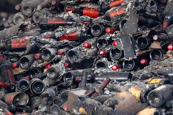 Bottles and burnt produce on the floor of the burnt Harcout Coolstore building.
