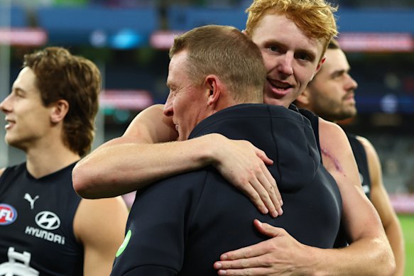 A relieved Michael Voss hugs it out with Blues young gun Harry Dean.