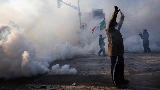 A person holds up their hands as law enforcement deploys a thick screen of teargas on Nicollet Avenue in Minneapolis.