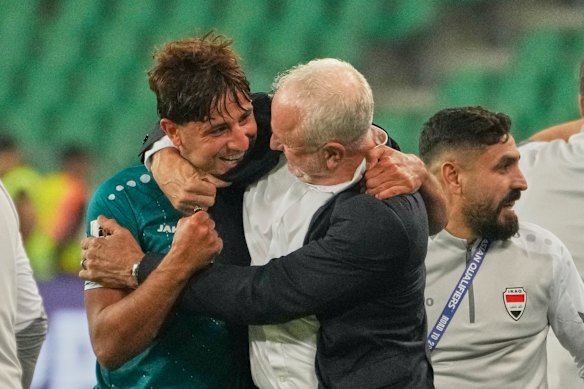 Iraq's Graham Arnold and Mohanad Ali celebrate their win.