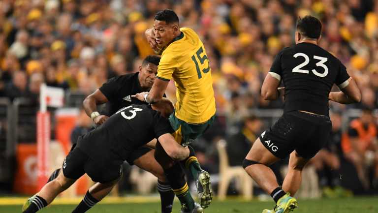 Casualty: Israel Folau is tackled by Jack Goodhue before the fullback left the field with an injury.