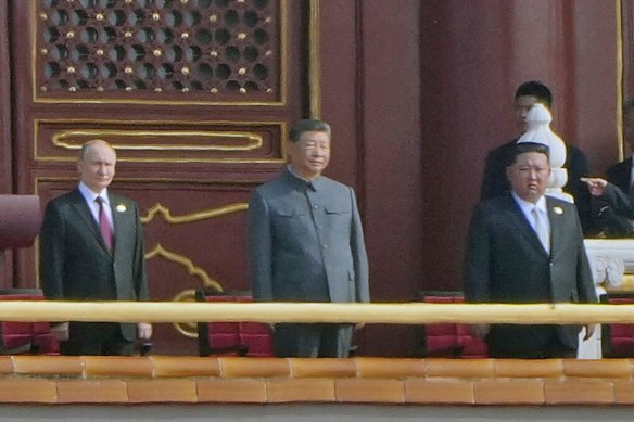 Putin, Xi and Kim prepare to watch the parade together.